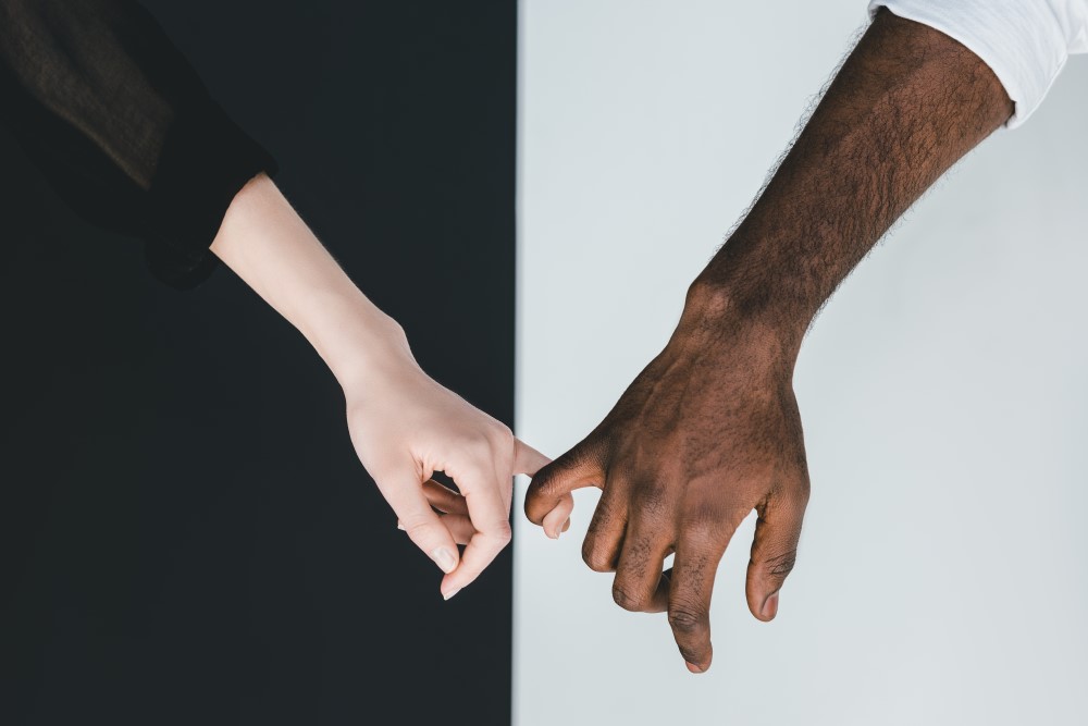 black and white hands together